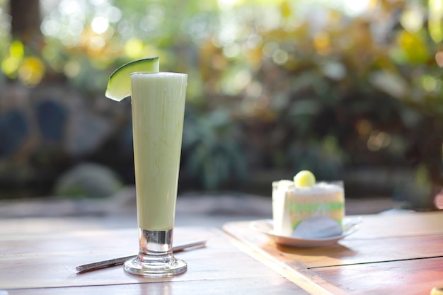 delicious and fresh melon frappe on wooden table at cafe menu in summer
