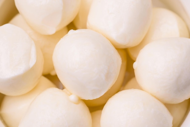 Delicious fresh mozzarella cheese in the form of small balls with salt and spices