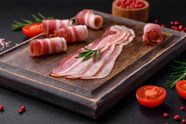 Delicious fresh pancetta with salt and spices cut into thin slices