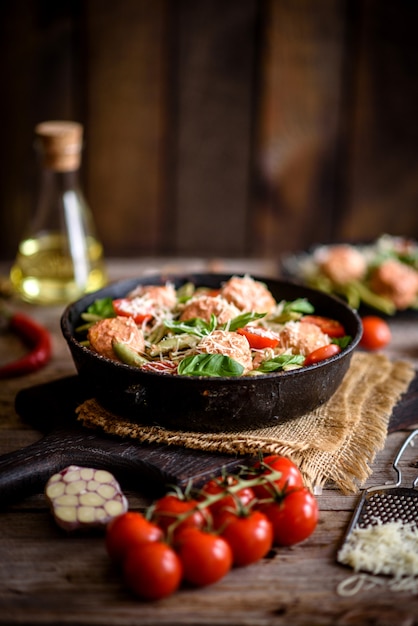 Delicious fresh pasta with meatballs in a pan