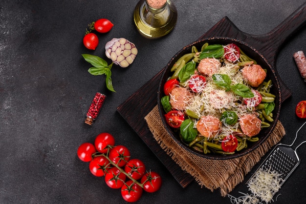 Delicious fresh pasta with meatballs, sauce, cherry tomatoes and basil