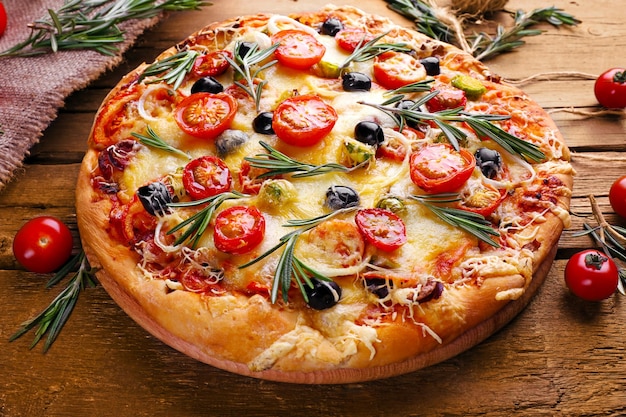 Delicious fresh pizza on wooden table closeup