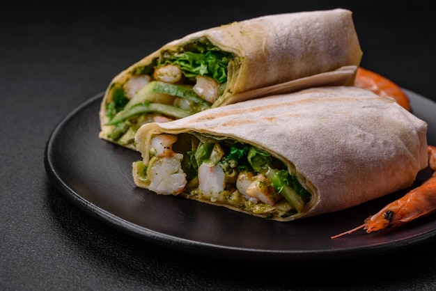 Delicious fresh roll with shrimps tomatoes lettuce and cucumber in pita bread