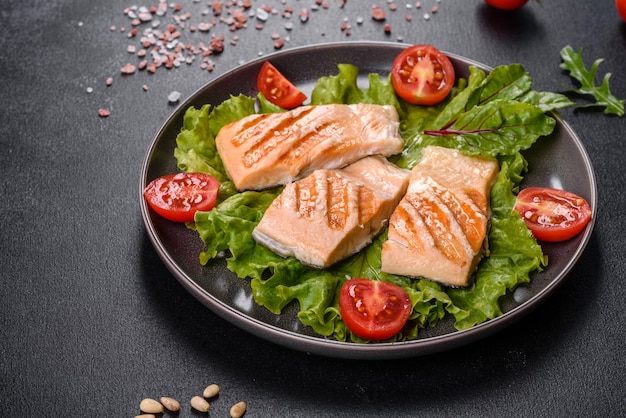 Delicious fresh salad with fish, tomatoes and lettuce leaves. Healthy food