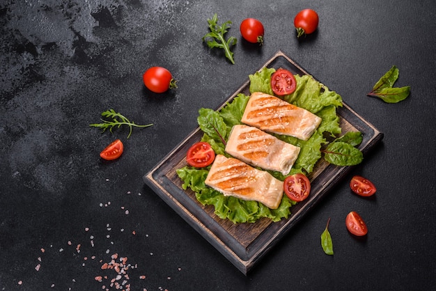 Delicious fresh salad with fish, tomatoes and lettuce leaves. Healthy food