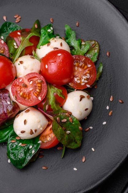 Delicious fresh salad with mozzarella cheese cherry tomatoes herbs salt and spices