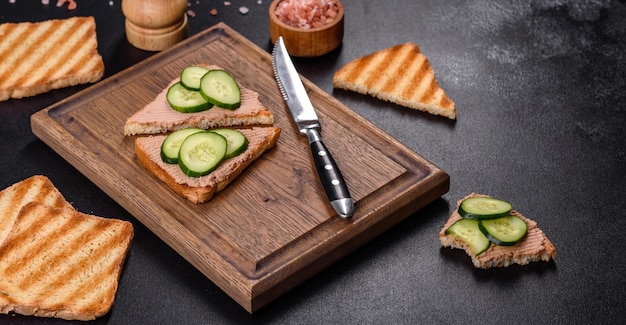 Delicious fresh sandwich with chicken liver pate with crispy toast butter and cucumber