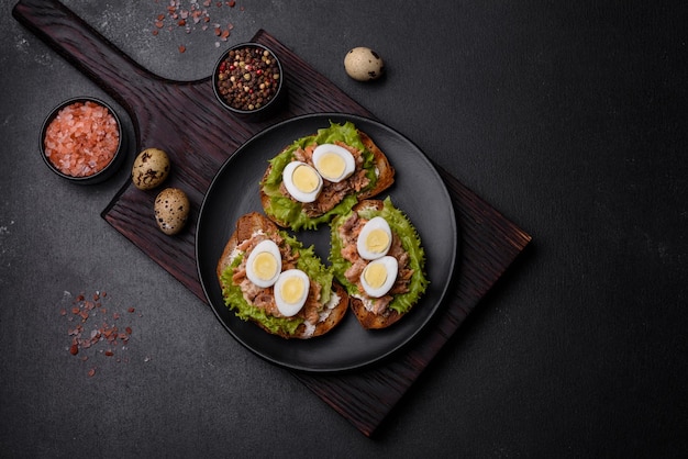 Delicious fresh sandwiches with toast canned salmon salad and quail eggs