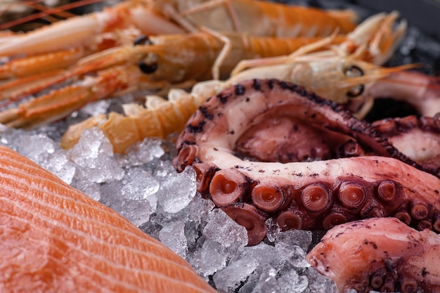 Delicious fresh seafood on ice Closeup Octopus salmon shrimp