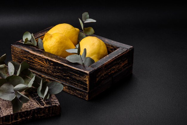 Delicious fresh yellow citrus fruits or lemon in a wooden box