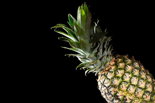 Delicious fresh yellow pineapple tropical fruit on black