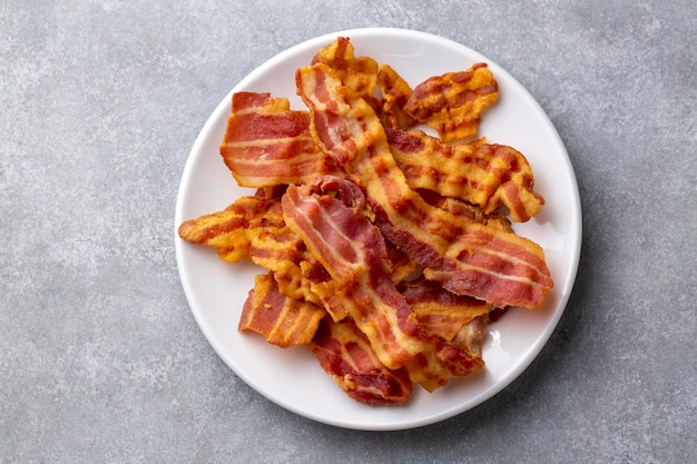 Delicious fried bacon served on plate.