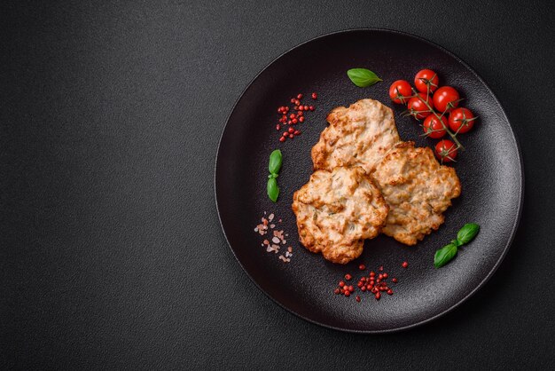 Delicious fried chicken chop or pork meat fried breaded with salt spices and herbs on a dark concrete background