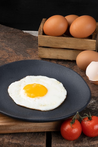 Delicious fried egg on black plate