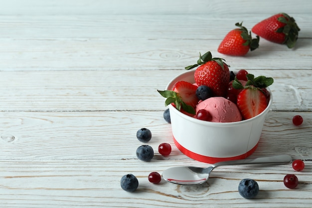Delicious fruit ice cream on white wooden table