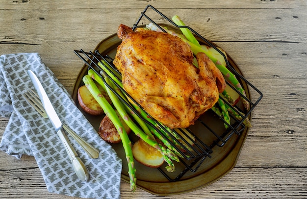 Delicious golden crispy skin chicken grilled in oven with potato