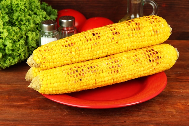 Delicious golden grilled corn on table on wooden background