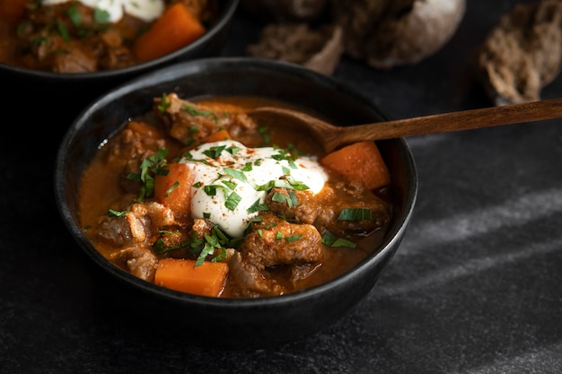 Delicious goulash stew on table