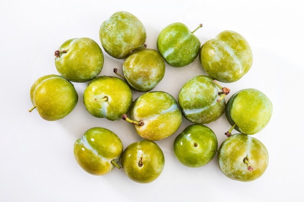 Delicious green plums fresh and raw claudias. Isolated