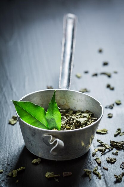 Delicious green tea on black wooden table