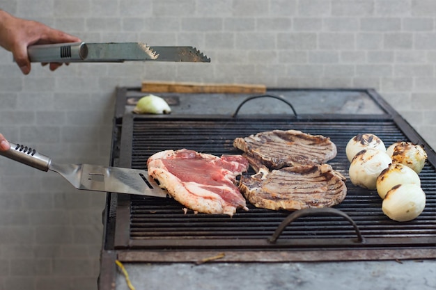 Delicious grilled meat being cooked by a person