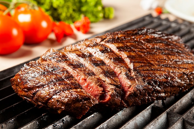 Delicious grilled meat over the grill on a barbecue