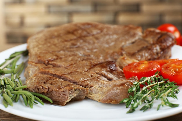 Delicious grilled meat on table closeup