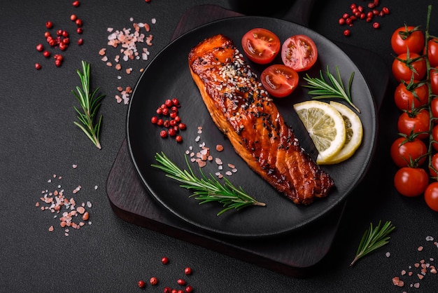 Delicious grilled red salmon fish with sauce sesame seeds spices and herbs