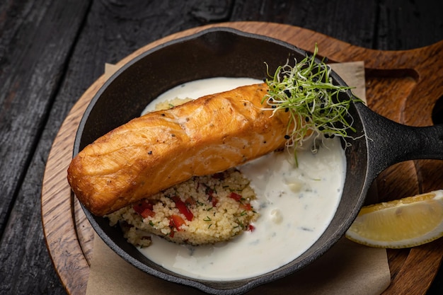 delicious grilled salmon in the restaurant. On a dark background