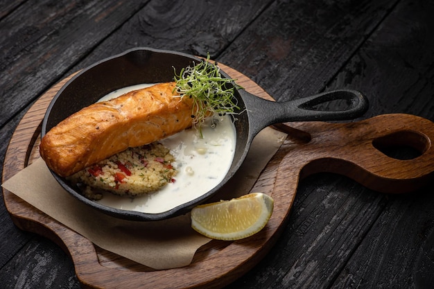 delicious grilled salmon in the restaurant. On a dark background