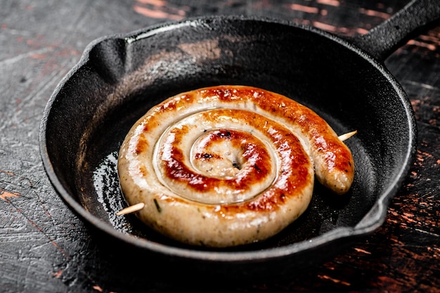 Delicious grilled sausage in a frying pan