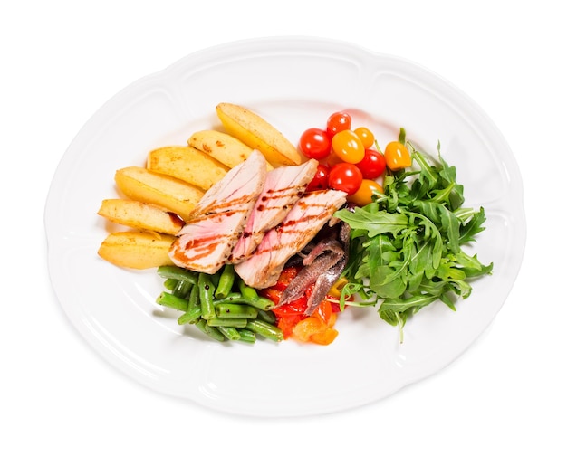 Delicious grilled tuna salad with baked potatoes and french beans Isolated on a white background