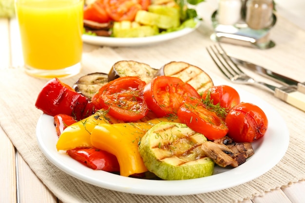 Delicious grilled vegetables on plate on table closeup