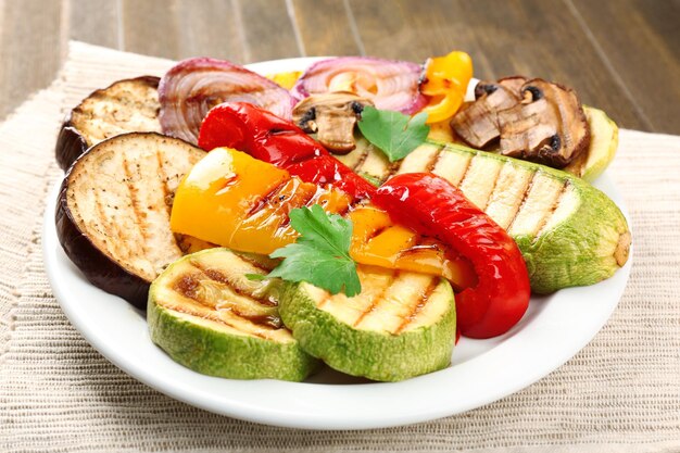 Delicious grilled vegetables on plate on table closeup