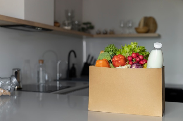 Photo delicious groceries in paper bag at home