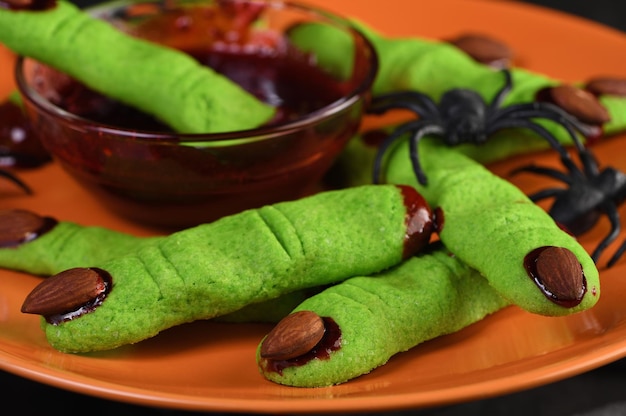 A delicious Halloween treat Witch's Fingers Green Sugar Cookies with raspberry jam and almonds are the perfect choice for paleo vegan look