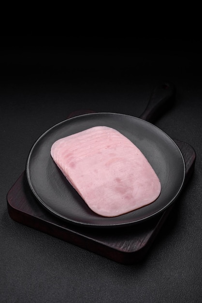 Delicious ham sliced with salt spices and herbs as ingredients for making sandwiches