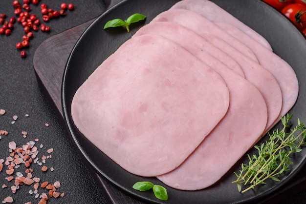 Delicious ham sliced with salt spices and herbs as ingredients for making sandwiches