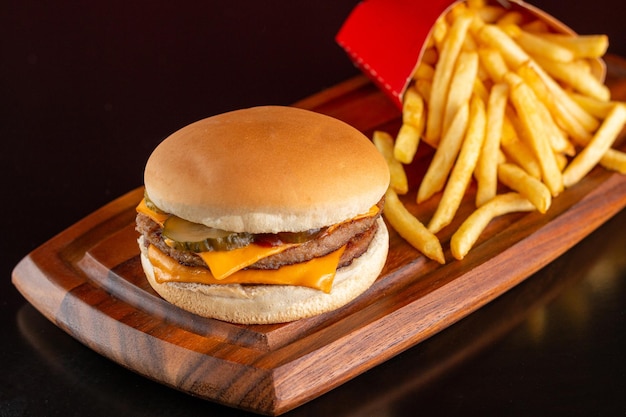 Delicious hamburger with cheddar cheese with french fries.