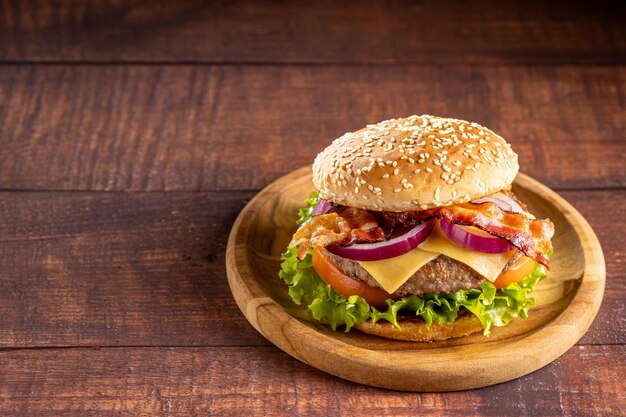 Delicious hamburger with meat cheese bacon and salad