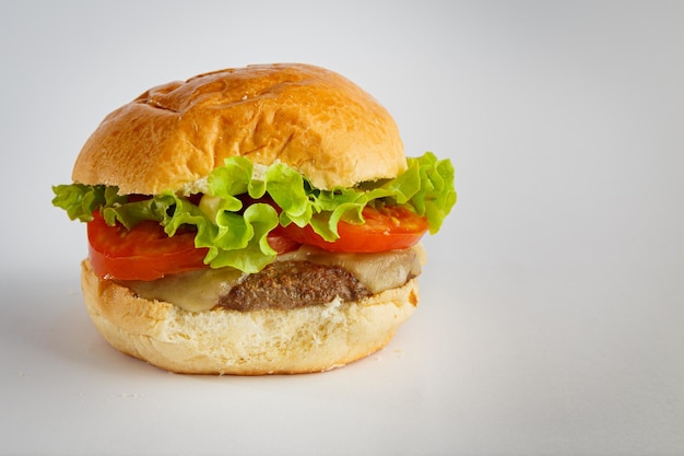 Delicious hamburger on wooden background Burger with tomato lettuce meat and cheese