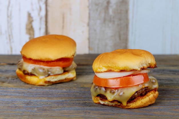 Delicious hamburgers on wooden background