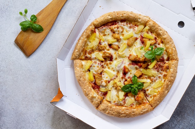 Delicious Hawaiian pizza in a cardboard box