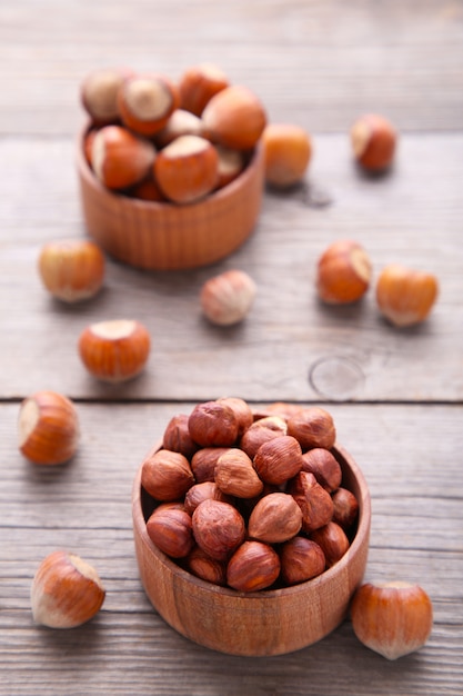 Delicious hazelnut in the wooden bowl on white 