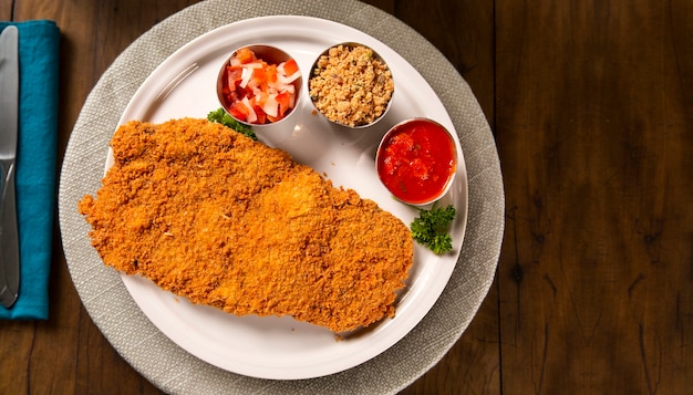 Delicious healthy food with breaded chicken fillet and sauces