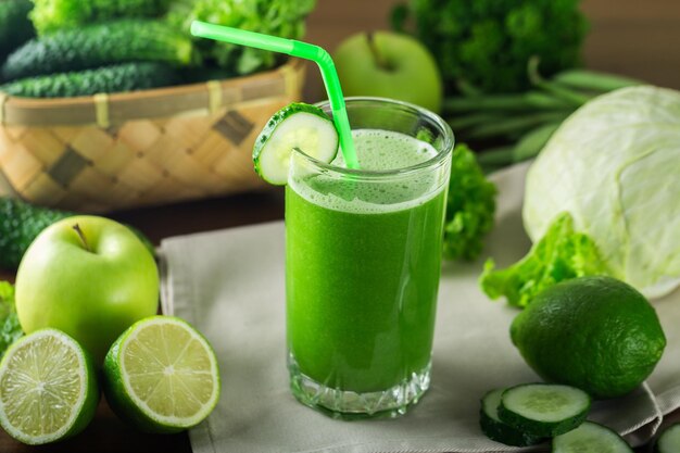 Delicious Healthy green smoothie with fruits and vegetables on table