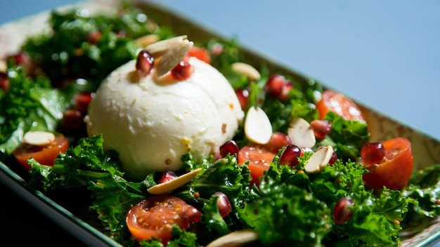 Delicious and healthy kale salad mozzarella cheese and cherry tomatoes