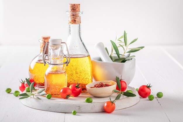 Delicious and healthy oil in bottle with dried tomatoes