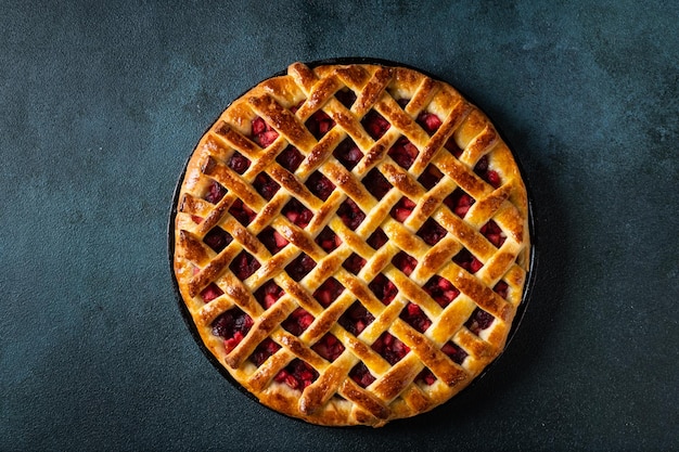 Delicious Homemade Cherry Pie with a Flaky Crust on dark background Top view American pie Cherry dessert Flatlay