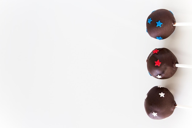 Delicious Homemade Chocolate cake pops on sticks White background Selective focus Copy space